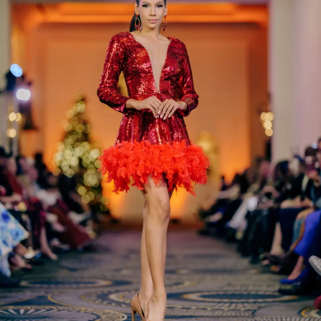 Fiery Pelé haute couture red gown with sequins and dramatic feather accents